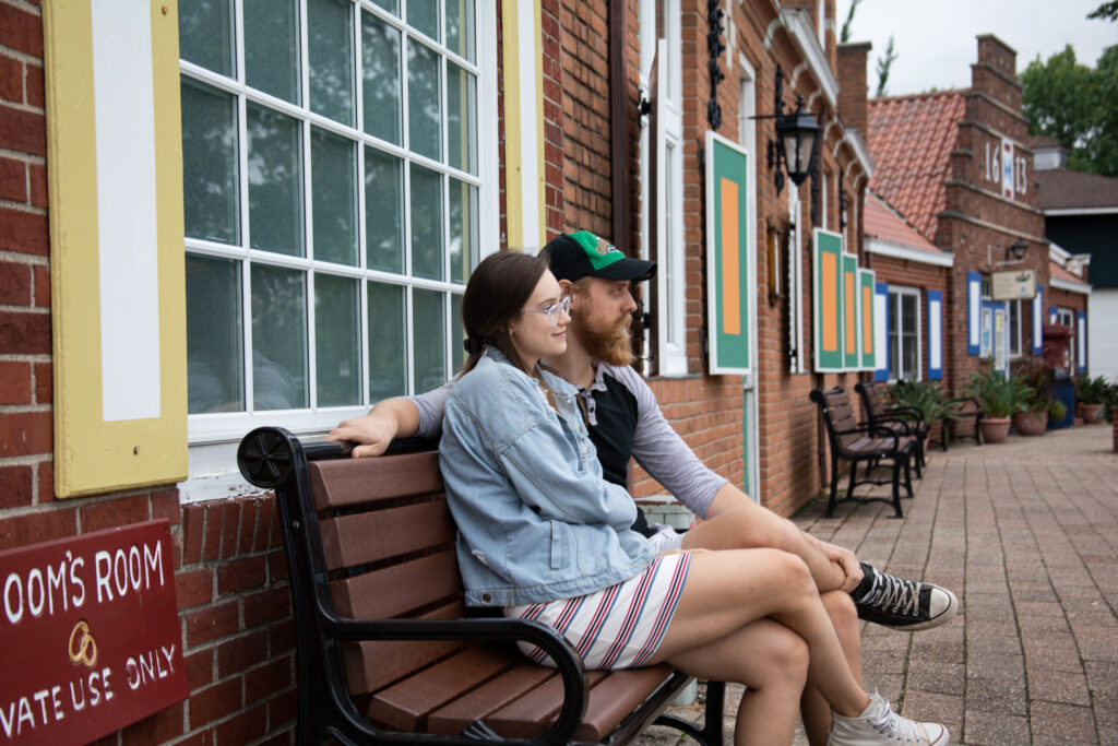 man and woman sitting on a bench.