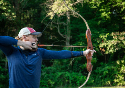 man holding bow and arrow
