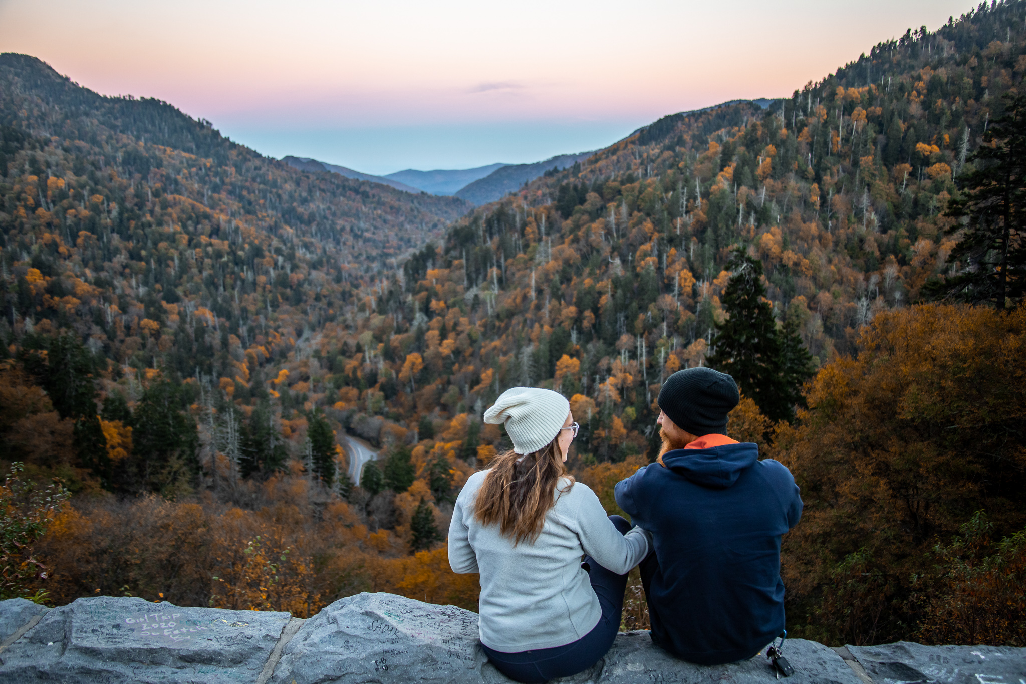 Two people sitting on a mountain